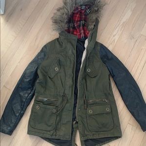 Green parka with black leather sleeves